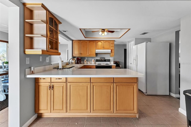 kitchen with kitchen peninsula, ceiling fan, light tile flooring, white appliances, and sink