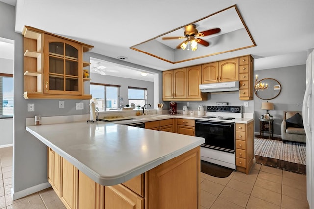 kitchen with white electric range, light tile floors, kitchen peninsula, and ceiling fan with notable chandelier