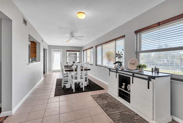 interior space with light tile floors and ceiling fan