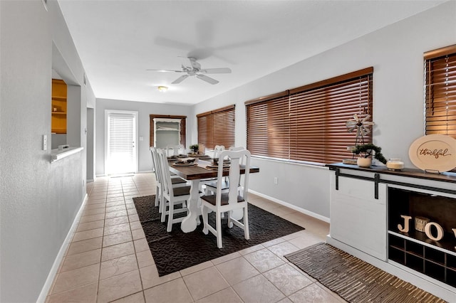 dining area featuring light tile flooring and ceiling fan