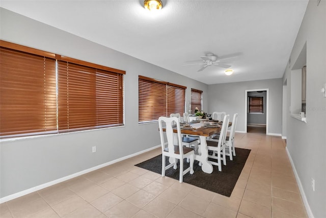 dining space featuring ceiling fan and light tile flooring