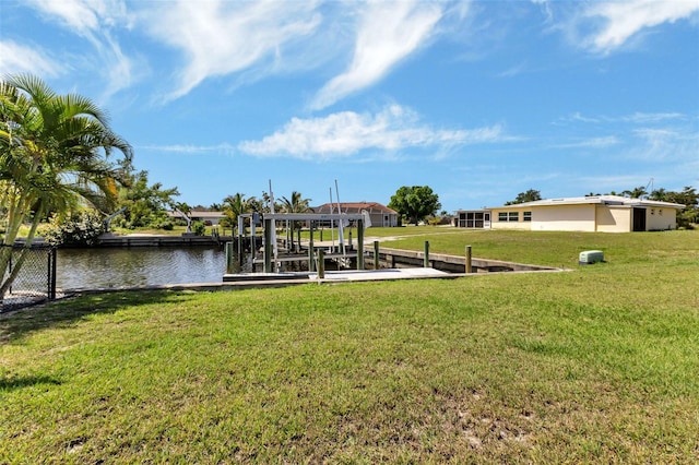 view of dock featuring a yard and a water view