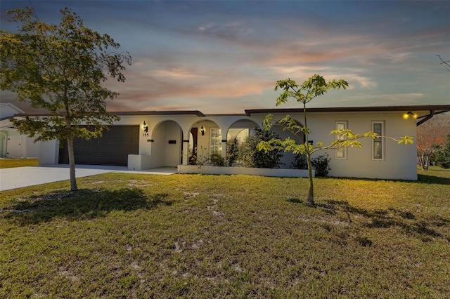 view of front of house with a lawn and a garage