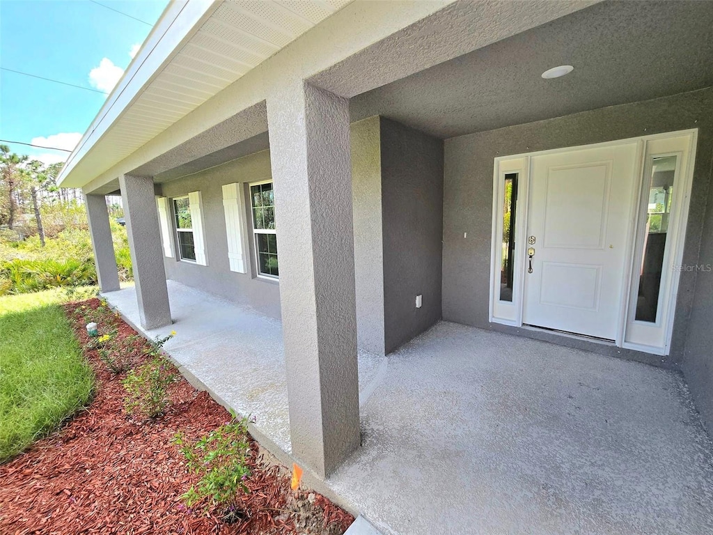 doorway to property featuring a patio area