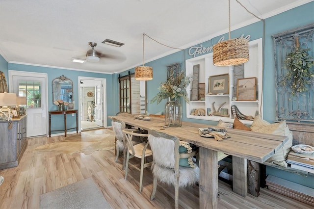 dining area with light hardwood / wood-style floors, ceiling fan, and crown molding