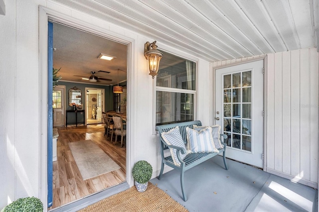 doorway to property featuring ceiling fan