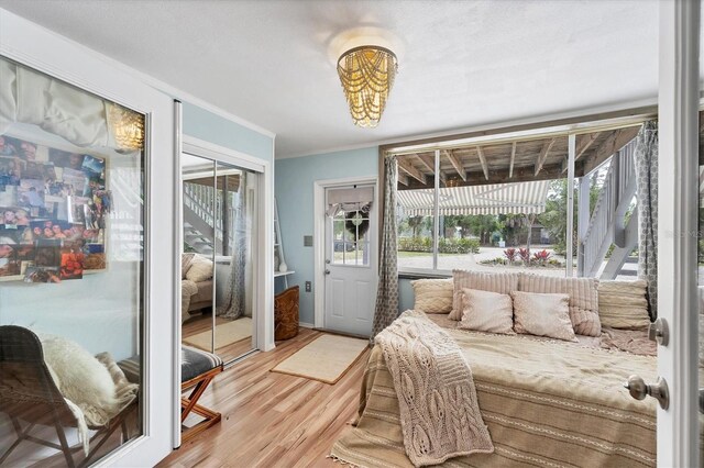 bedroom with ornamental molding and light wood-type flooring