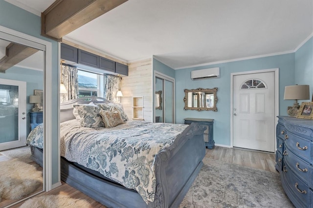 bedroom featuring a wall unit AC, light hardwood / wood-style floors, and crown molding