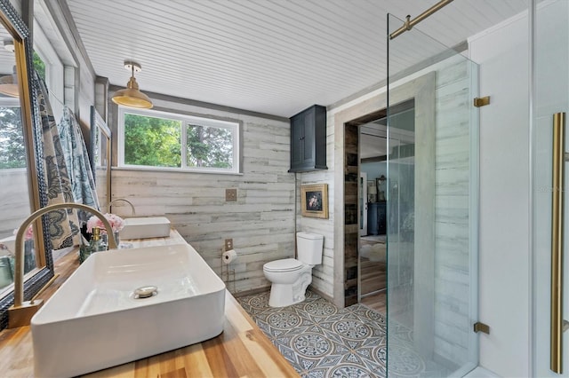 bathroom with a shower, toilet, wooden walls, and hardwood / wood-style floors