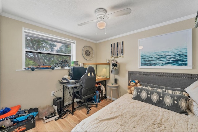 bedroom with ceiling fan, light hardwood / wood-style flooring, a textured ceiling, and crown molding