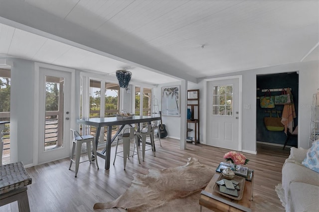 interior space featuring beamed ceiling and light hardwood / wood-style flooring