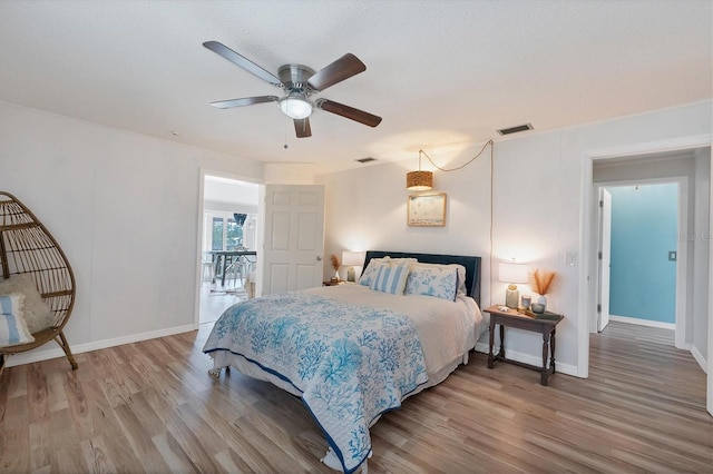 bedroom with wood-type flooring and ceiling fan