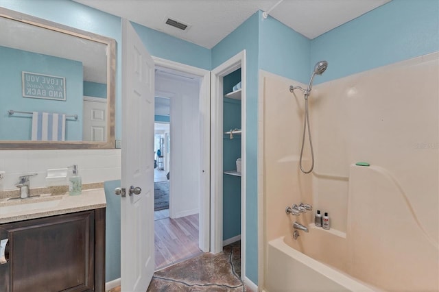 bathroom with vanity, hardwood / wood-style floors, backsplash, french doors, and shower / bath combination