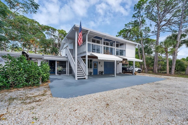 back of house featuring a carport