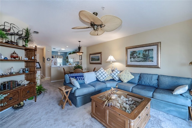 living room featuring light colored carpet and ceiling fan