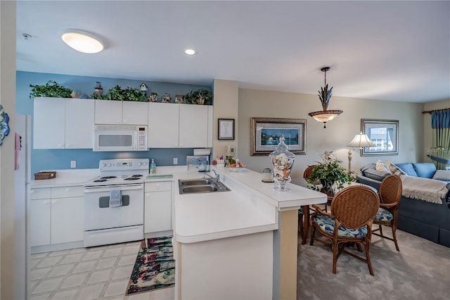 kitchen featuring white cabinets, sink, white appliances, light colored carpet, and pendant lighting