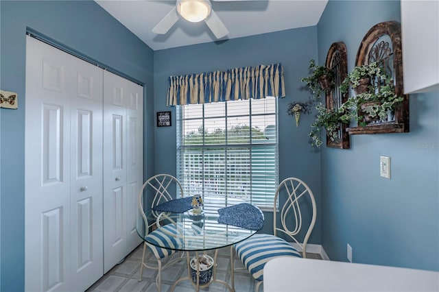 dining room with ceiling fan and light tile flooring