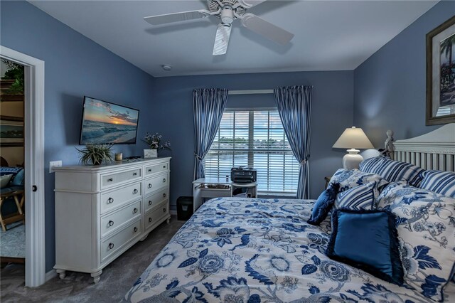 bedroom with dark colored carpet and ceiling fan