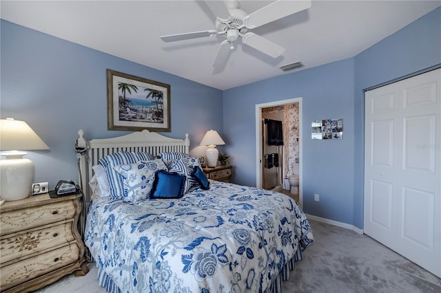 bedroom with ensuite bath, light carpet, ceiling fan, and a closet