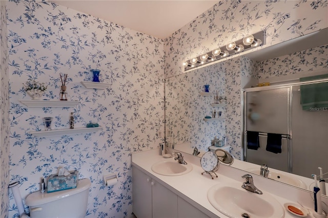 bathroom with dual sinks, toilet, and vanity with extensive cabinet space