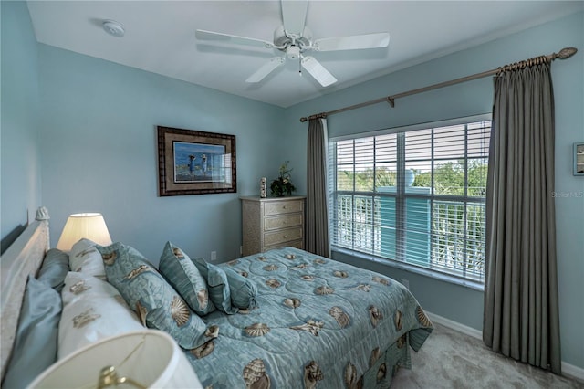 bedroom featuring light colored carpet and ceiling fan