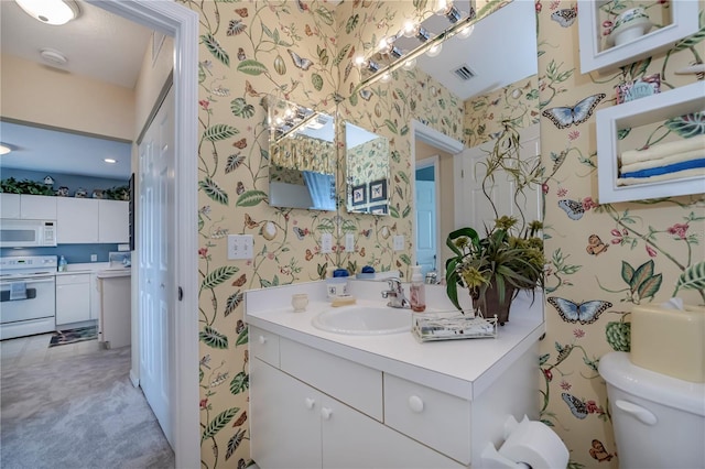 bathroom with toilet and large vanity