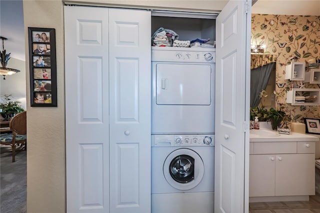 laundry room featuring light colored carpet and stacked washing maching and dryer