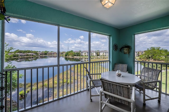 sunroom / solarium with a water view