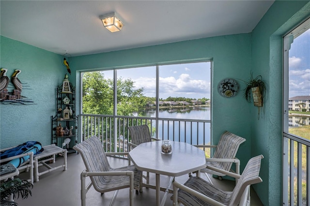 sunroom featuring a water view and a wealth of natural light