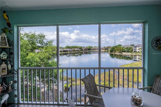 unfurnished sunroom with a water view