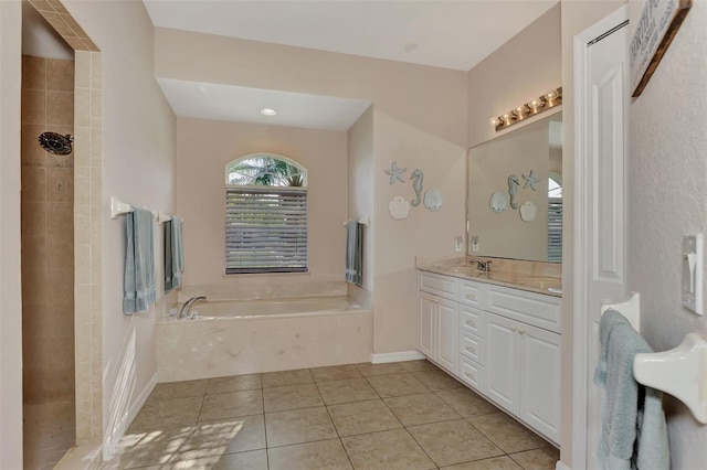 bathroom featuring tile flooring, double vanity, and a tub