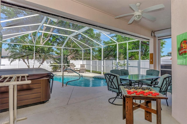 view of pool featuring a hot tub, ceiling fan, a lanai, and a patio