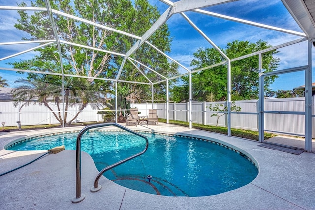 view of pool with a lanai and a patio area