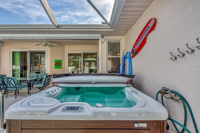 exterior space featuring ceiling fan and a hot tub