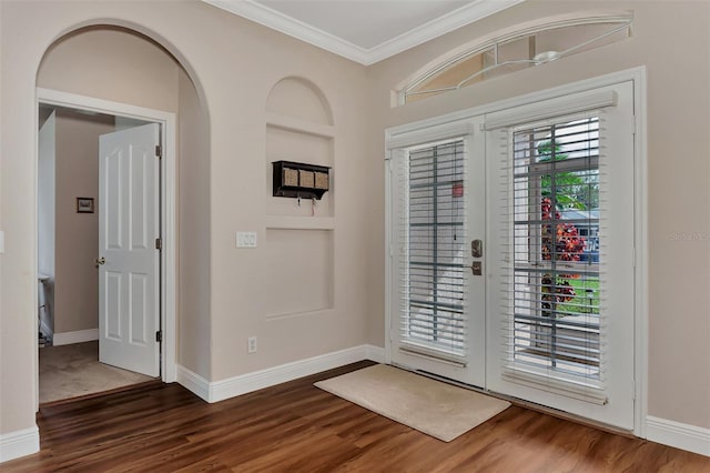 foyer featuring french doors, dark wood-type flooring, and ornamental molding