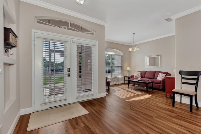 foyer featuring plenty of natural light, french doors, dark hardwood / wood-style flooring, and an inviting chandelier