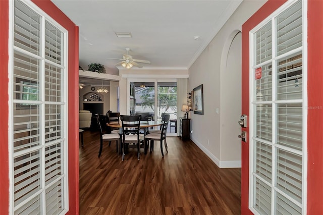 dining space with crown molding, ceiling fan, and dark hardwood / wood-style floors