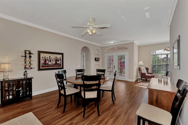 dining space with french doors, ornamental molding, dark hardwood / wood-style flooring, and ceiling fan