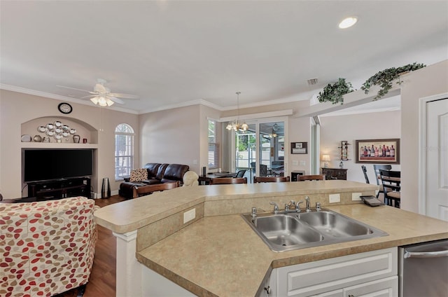 kitchen featuring white cabinets, ceiling fan with notable chandelier, dark wood-type flooring, stainless steel dishwasher, and sink