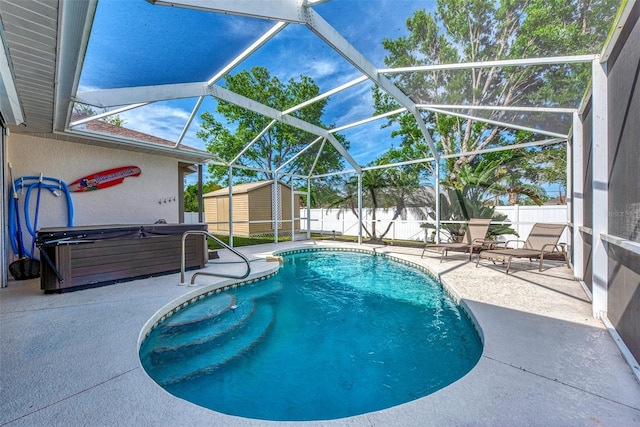 view of swimming pool with a patio, a storage unit, and glass enclosure