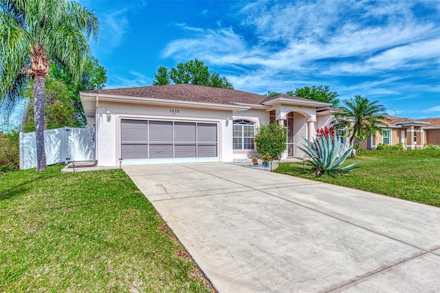 view of front of home featuring a front yard and a garage