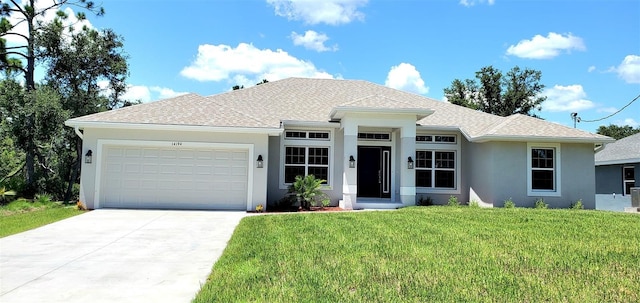 view of front facade with a garage and a front yard