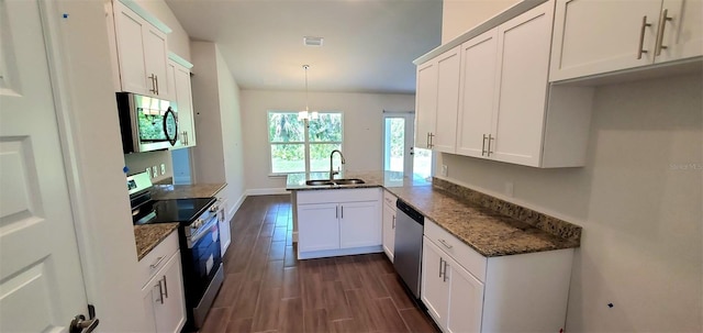 kitchen featuring decorative light fixtures, sink, white cabinets, kitchen peninsula, and stainless steel appliances