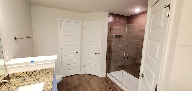 bathroom featuring walk in shower, vanity, and toilet