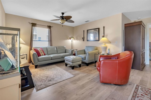 living room featuring light hardwood / wood-style floors and ceiling fan