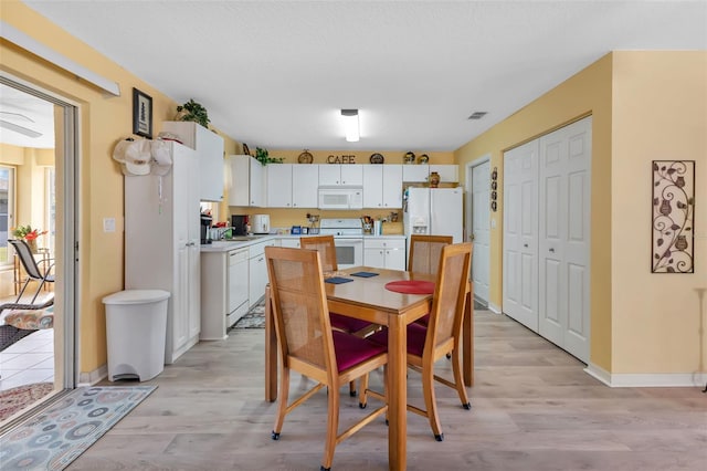 dining room featuring sink and light wood-type flooring