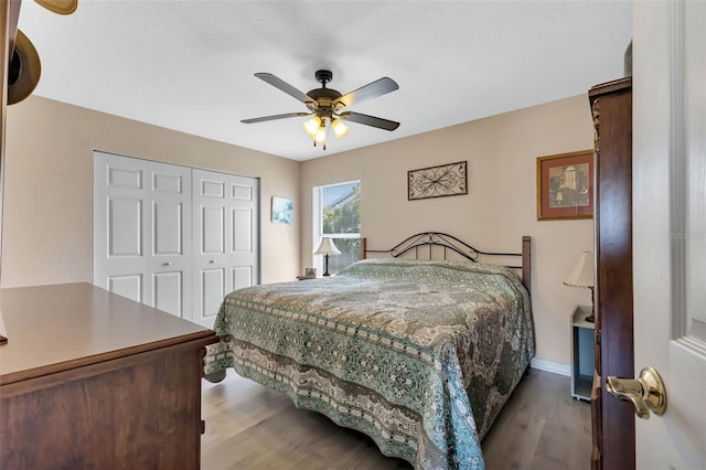 bedroom featuring dark hardwood / wood-style flooring, a closet, and ceiling fan