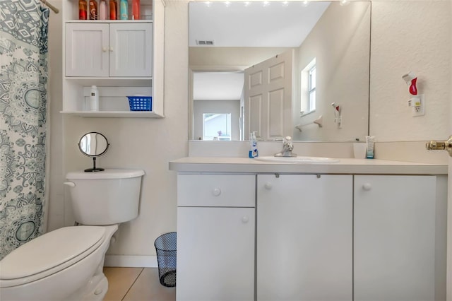 bathroom featuring toilet, tile floors, and vanity