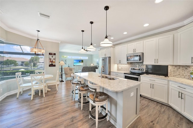 kitchen featuring hanging light fixtures, stainless steel appliances, and a healthy amount of sunlight