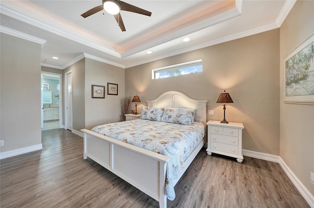 bedroom with ceiling fan, a tray ceiling, and dark wood-type flooring